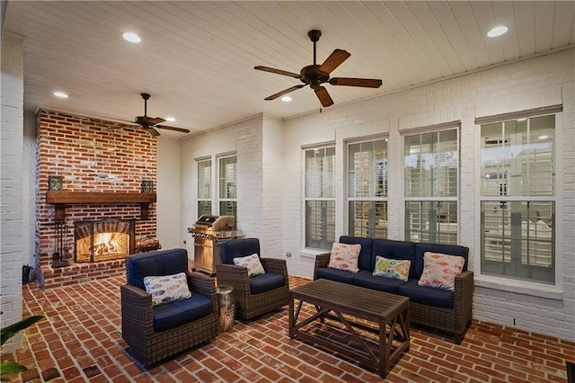 view of patio / terrace featuring an outdoor living space with a fireplace and ceiling fan