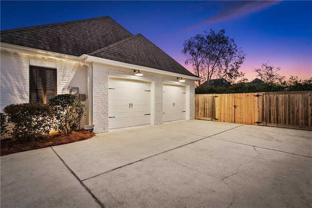 property exterior at dusk featuring a garage