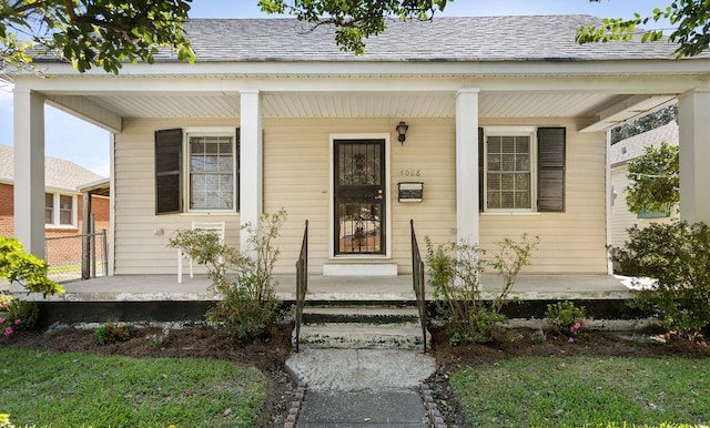 view of exterior entry with covered porch