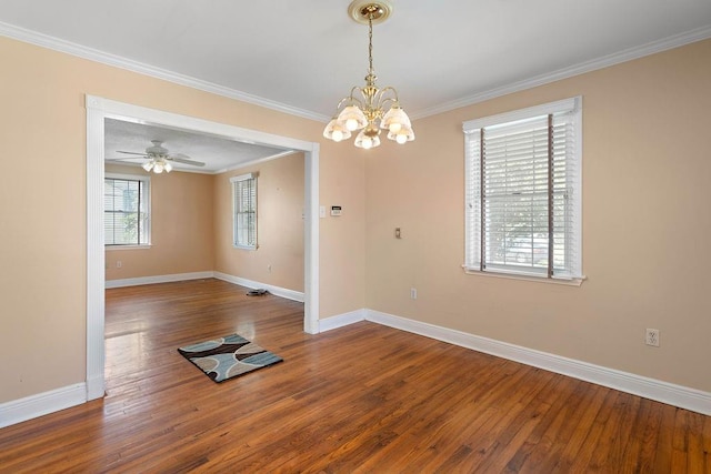 spare room with ceiling fan with notable chandelier, hardwood / wood-style floors, and crown molding