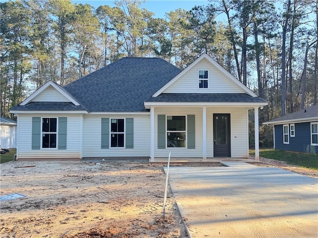 view of front facade featuring a porch and a shingled roof