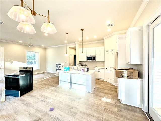 kitchen with white cabinets, light wood-style floors, visible vents, and appliances with stainless steel finishes