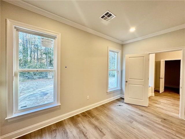 unfurnished bedroom with visible vents, multiple windows, crown molding, and baseboards