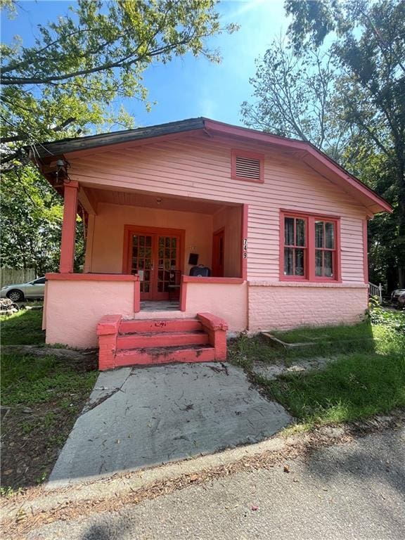 view of front of property with french doors and covered porch