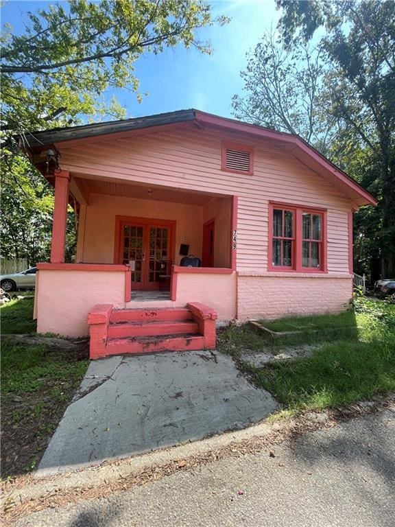 view of front of home featuring a porch and french doors