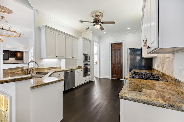 kitchen with white cabinets, sink, kitchen peninsula, appliances with stainless steel finishes, and dark hardwood / wood-style floors