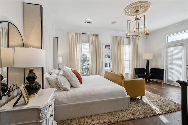 bedroom with a chandelier, ornamental molding, and dark tile patterned floors