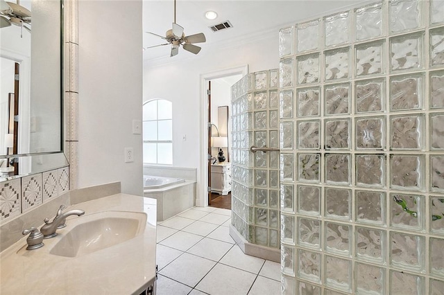 bathroom featuring shower with separate bathtub, tile patterned flooring, crown molding, ceiling fan, and vanity