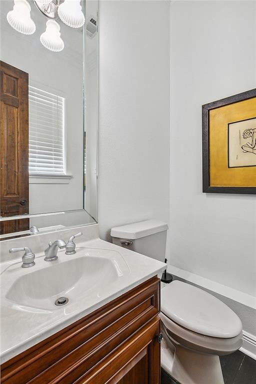 bathroom with vanity, toilet, and tile patterned floors