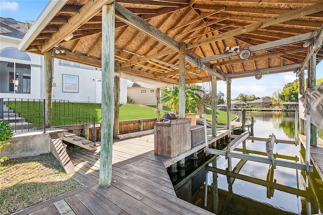 dock area featuring a water view and a yard