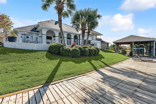 back of house featuring a gazebo and a yard