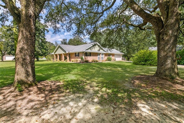 ranch-style house featuring a front lawn and a garage