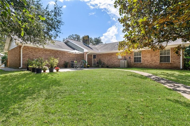 single story home with a patio area, a front lawn, and central AC unit