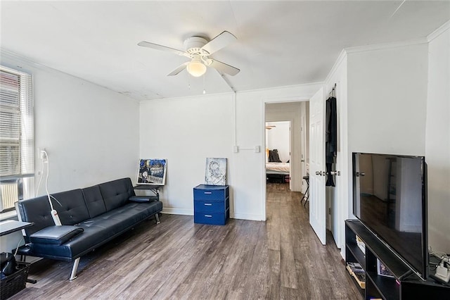 living room with ceiling fan, dark hardwood / wood-style floors, and crown molding