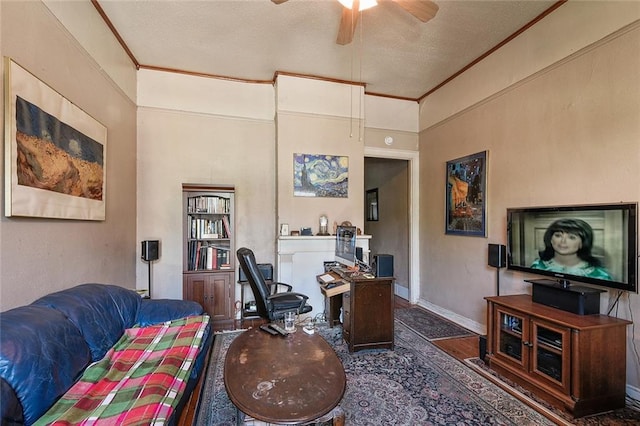 living room with a textured ceiling, ornamental molding, and ceiling fan