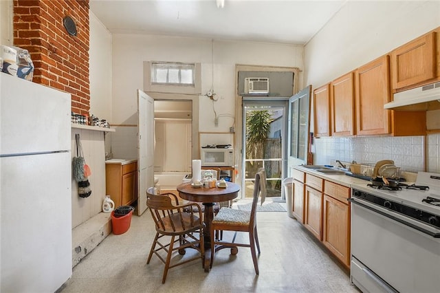 kitchen featuring white appliances, sink, exhaust hood, and tasteful backsplash