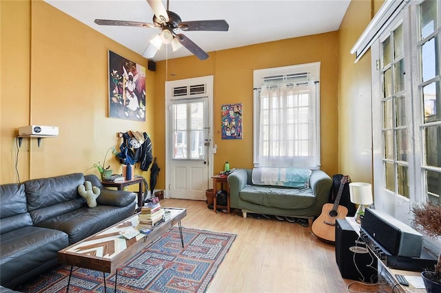 living room with ceiling fan and light hardwood / wood-style floors