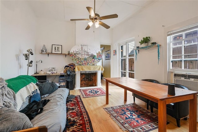 living room featuring ceiling fan, cooling unit, and hardwood / wood-style floors