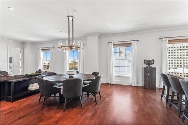 dining room featuring ornamental molding and dark wood-type flooring