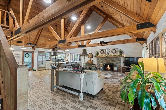 living room with a fireplace, beam ceiling, high vaulted ceiling, and wooden ceiling