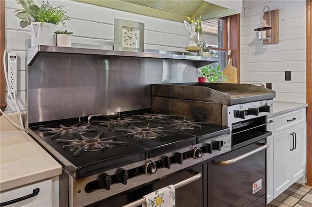 kitchen featuring white cabinets and high end stove