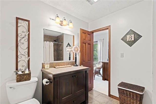 bathroom featuring vanity, toilet, curtained shower, a textured ceiling, and tile patterned flooring