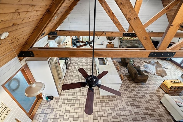 interior details featuring beam ceiling, tile patterned flooring, and wood walls