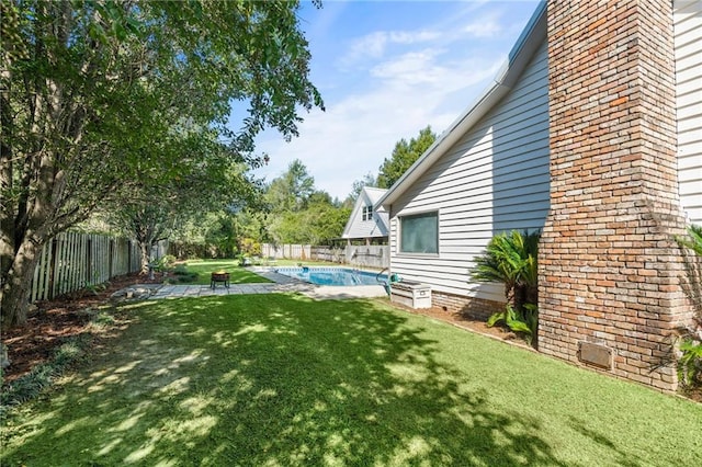 view of yard featuring a patio and a fenced in pool