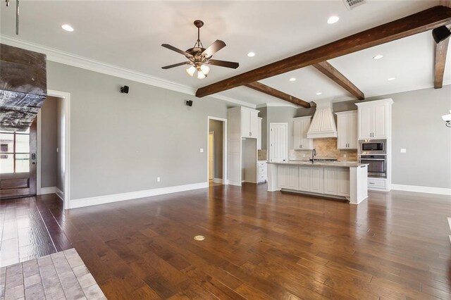 living room featuring beam ceiling, dark hardwood / wood-style floors, ceiling fan with notable chandelier, and ornamental molding