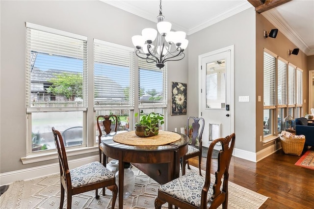 dining space featuring ornamental molding, wood-type flooring, and an inviting chandelier