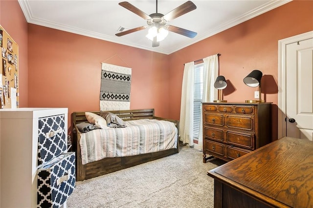 bedroom with ceiling fan, crown molding, and carpet floors