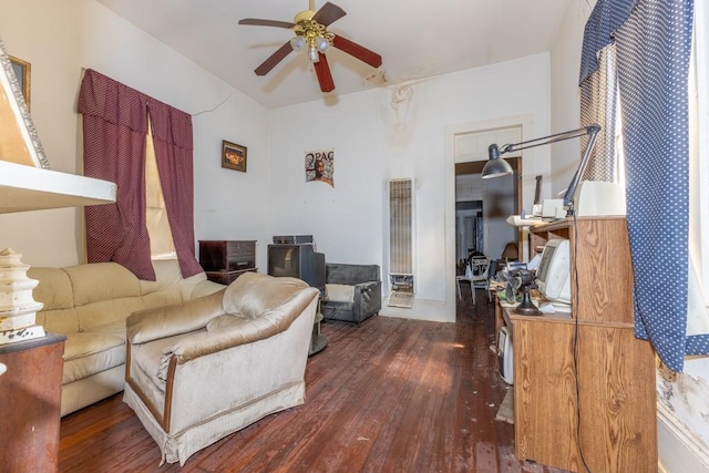 living room featuring dark hardwood / wood-style flooring and ceiling fan