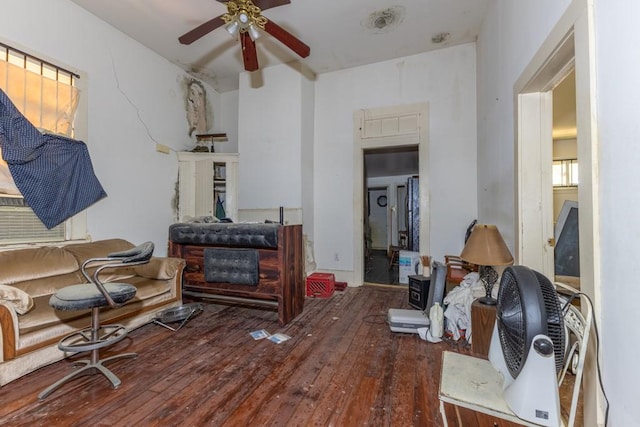 living room featuring ceiling fan and hardwood / wood-style floors