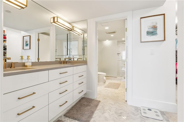 bathroom with vanity, toilet, and a shower with door