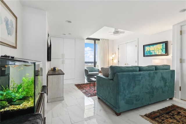 living room with ceiling fan and floor to ceiling windows