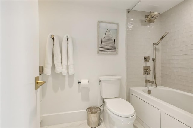 bathroom with tiled shower / bath combo and toilet