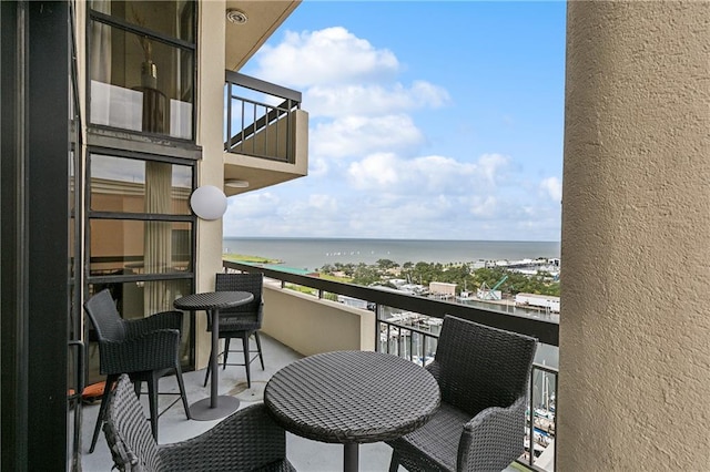 balcony featuring a water view