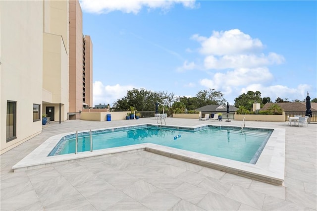 view of swimming pool with a patio area