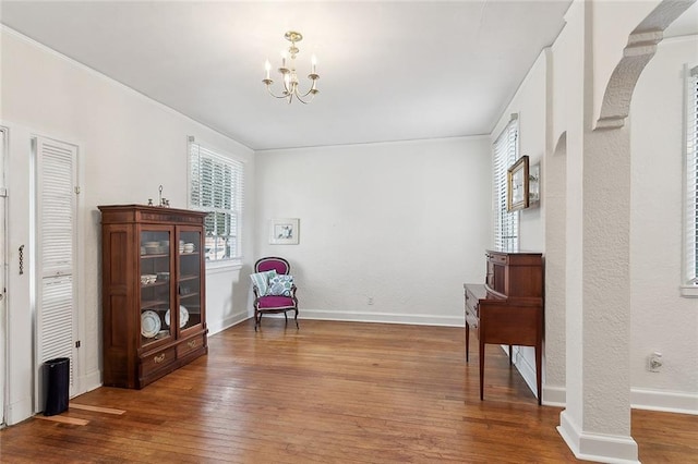 sitting room featuring hardwood / wood-style flooring and an inviting chandelier