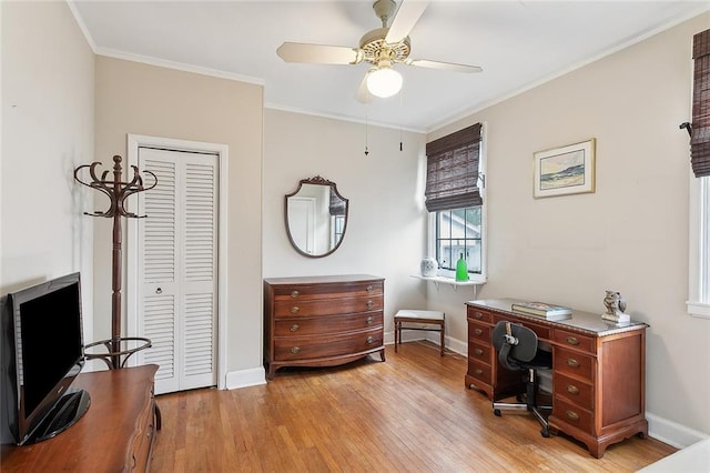 office featuring ornamental molding, light wood-type flooring, and ceiling fan