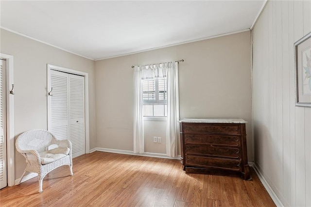 unfurnished room featuring crown molding, light hardwood / wood-style floors, and wood walls