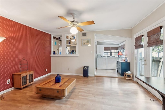 living room featuring washer and dryer, ornamental molding, light wood-type flooring, and ceiling fan