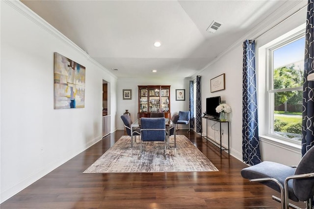 living area featuring dark hardwood / wood-style floors, crown molding, and a wealth of natural light