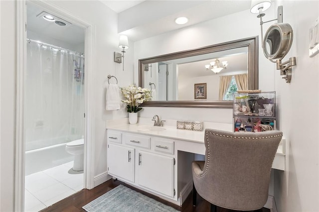 full bathroom with hardwood / wood-style floors, vanity, toilet, and shower / bath combination with curtain