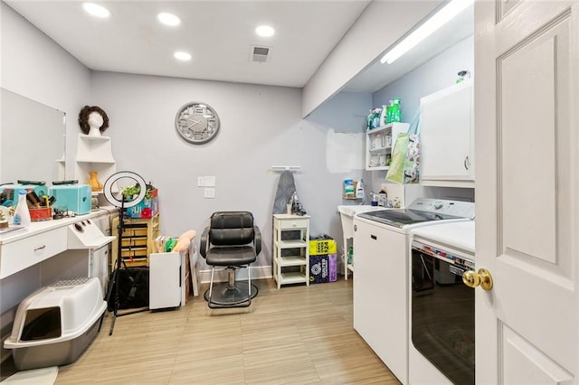 laundry area featuring cabinets and washer and clothes dryer