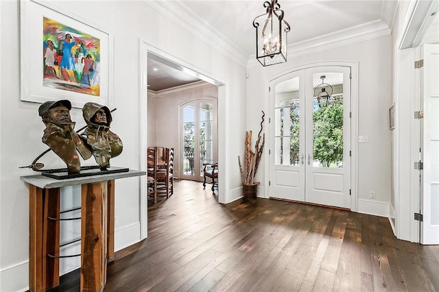 foyer entrance with dark wood-type flooring, french doors, and crown molding