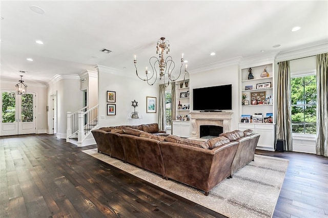 living room featuring dark hardwood / wood-style floors, a healthy amount of sunlight, and an inviting chandelier