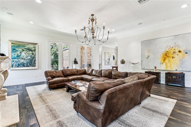 living room with an inviting chandelier, crown molding, a fireplace, and dark hardwood / wood-style flooring