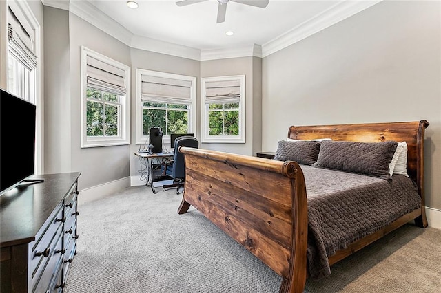 bedroom featuring multiple windows, crown molding, ceiling fan, and light colored carpet