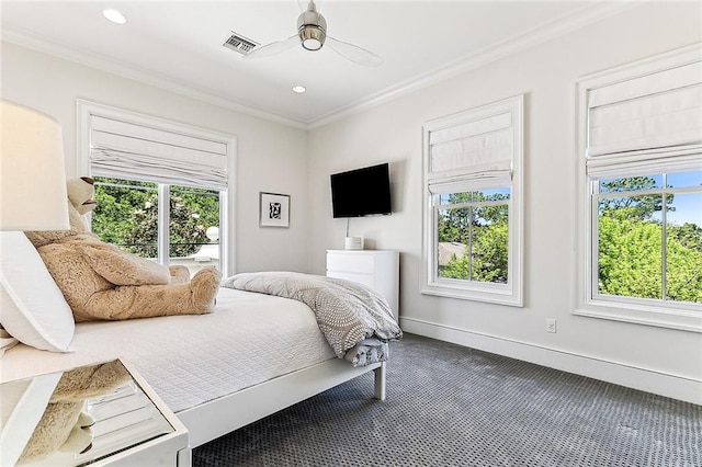 bedroom featuring ceiling fan, ornamental molding, carpet flooring, and multiple windows